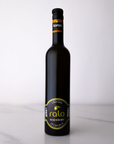 Black koroni olive oil bottle with a label on a white background