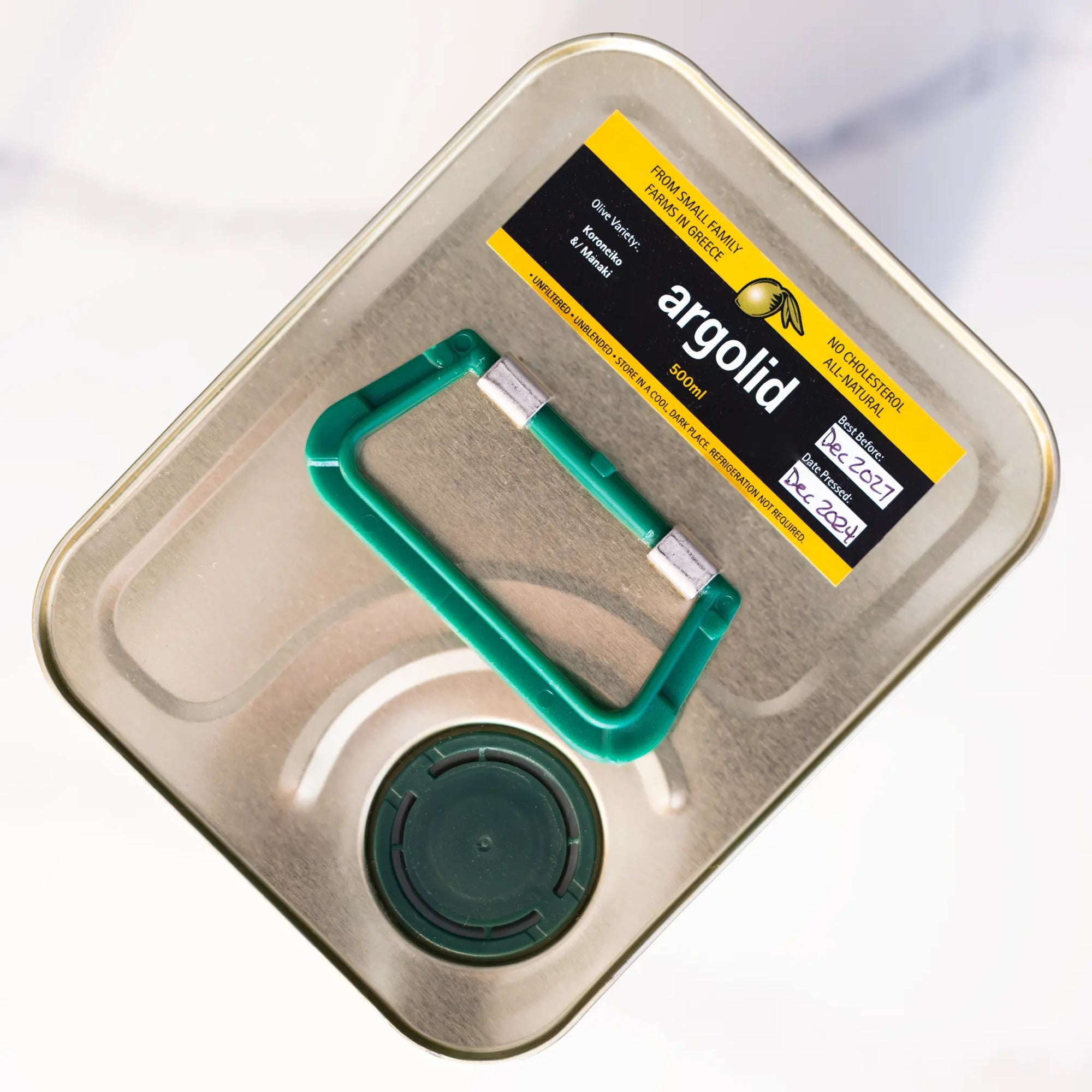 Top of metal tin with green handle, pouring spout, and 'argolid' olive oil sticker