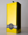 Yellow olive oil tin with a label on a gray background